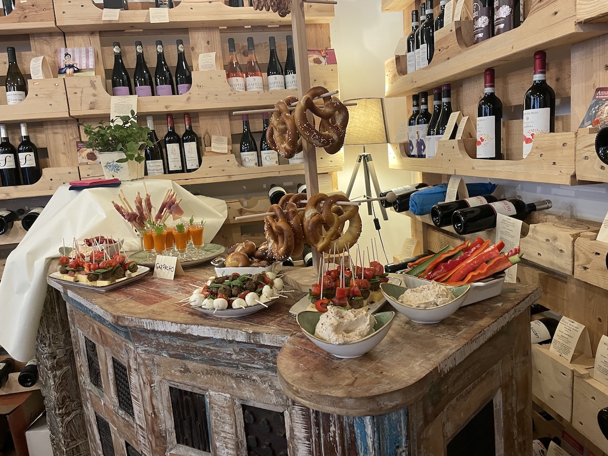 Auf einem rustikalen Tisch sind verschiedene Snack, Dips und Getränke wie ein Buffet angerichtet.